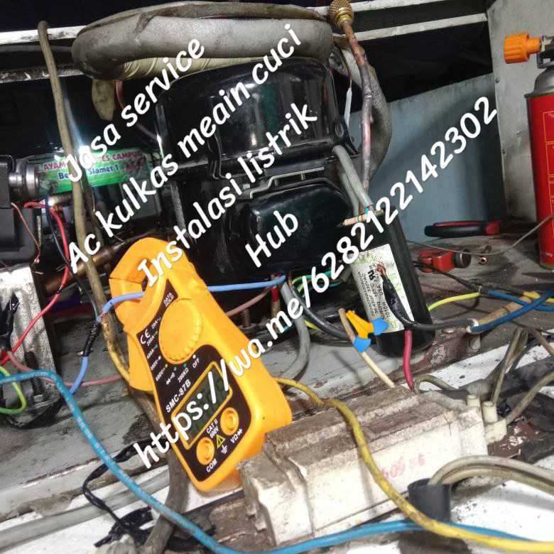 Technician repairing a household refrigerator using multimeter and tools, open fridge panel, realistic photo, Indonesian home kitchen.